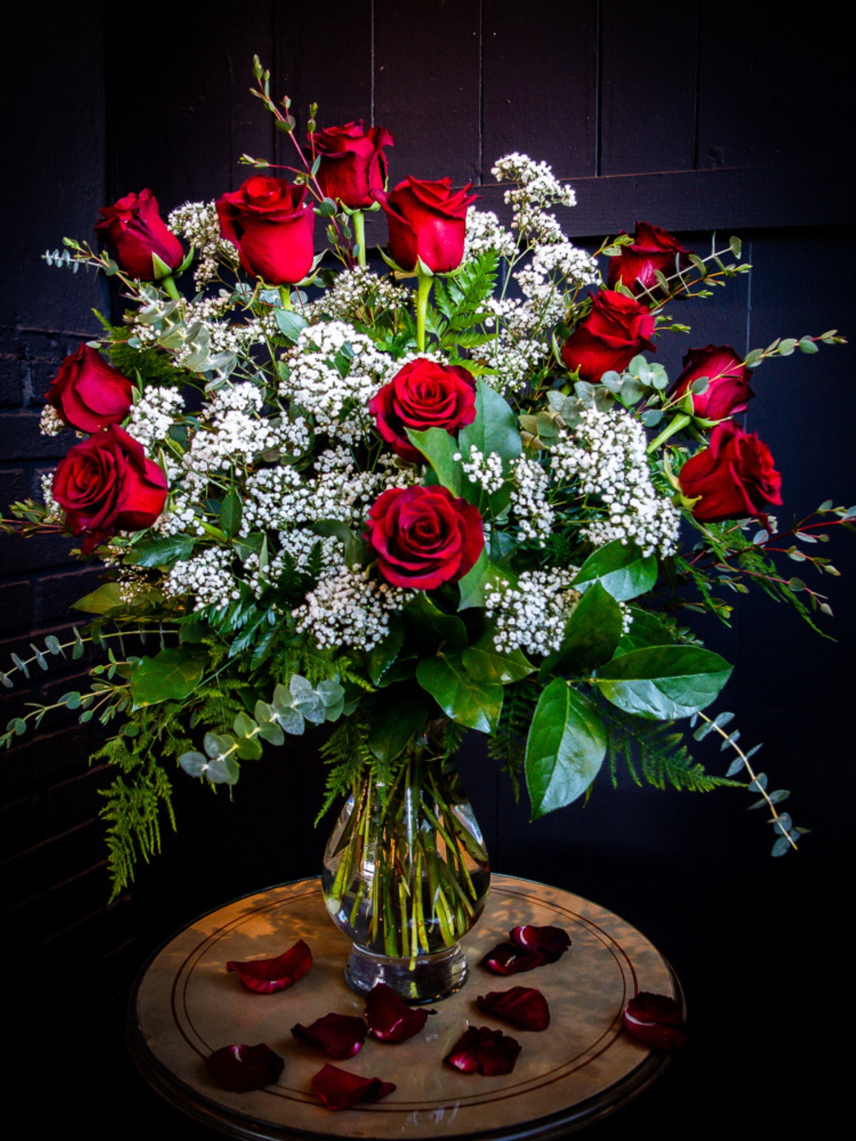 One dozen red rose flower arrangement with baby's breath from The Flower Cart