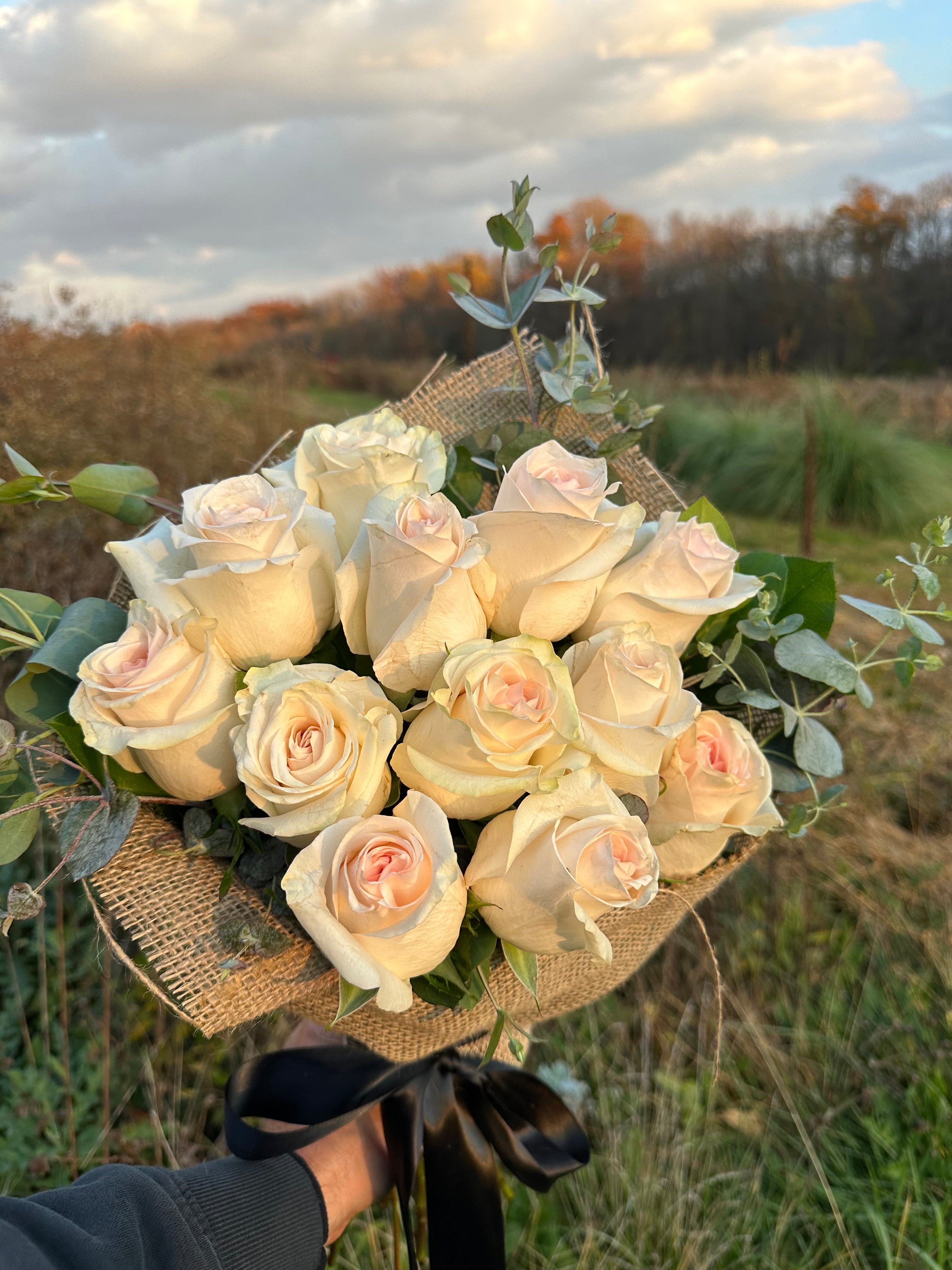 White rose flower bouquet wrapped in burlap from The Flower Cart